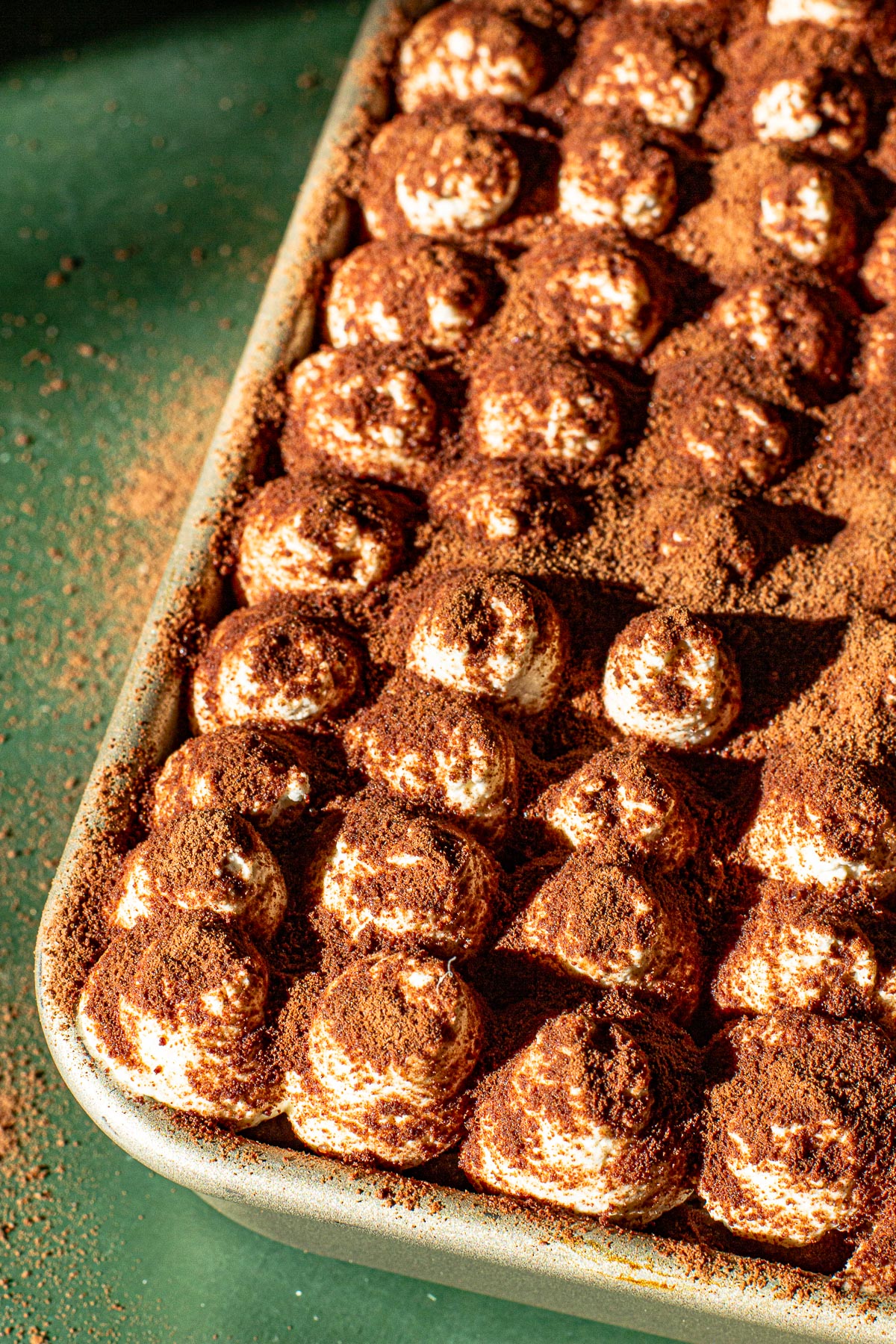 Finished Milo Tiramisu - Eggless and easy.  On a green backdrop.