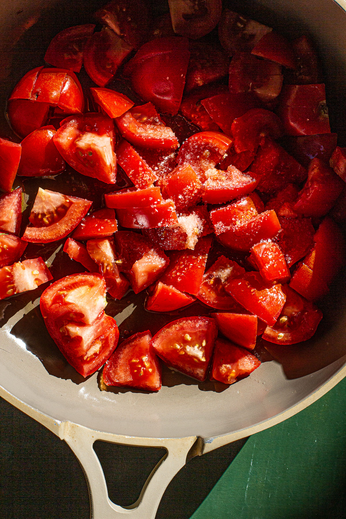 Chopped Tomatoes with salt in a skillet.