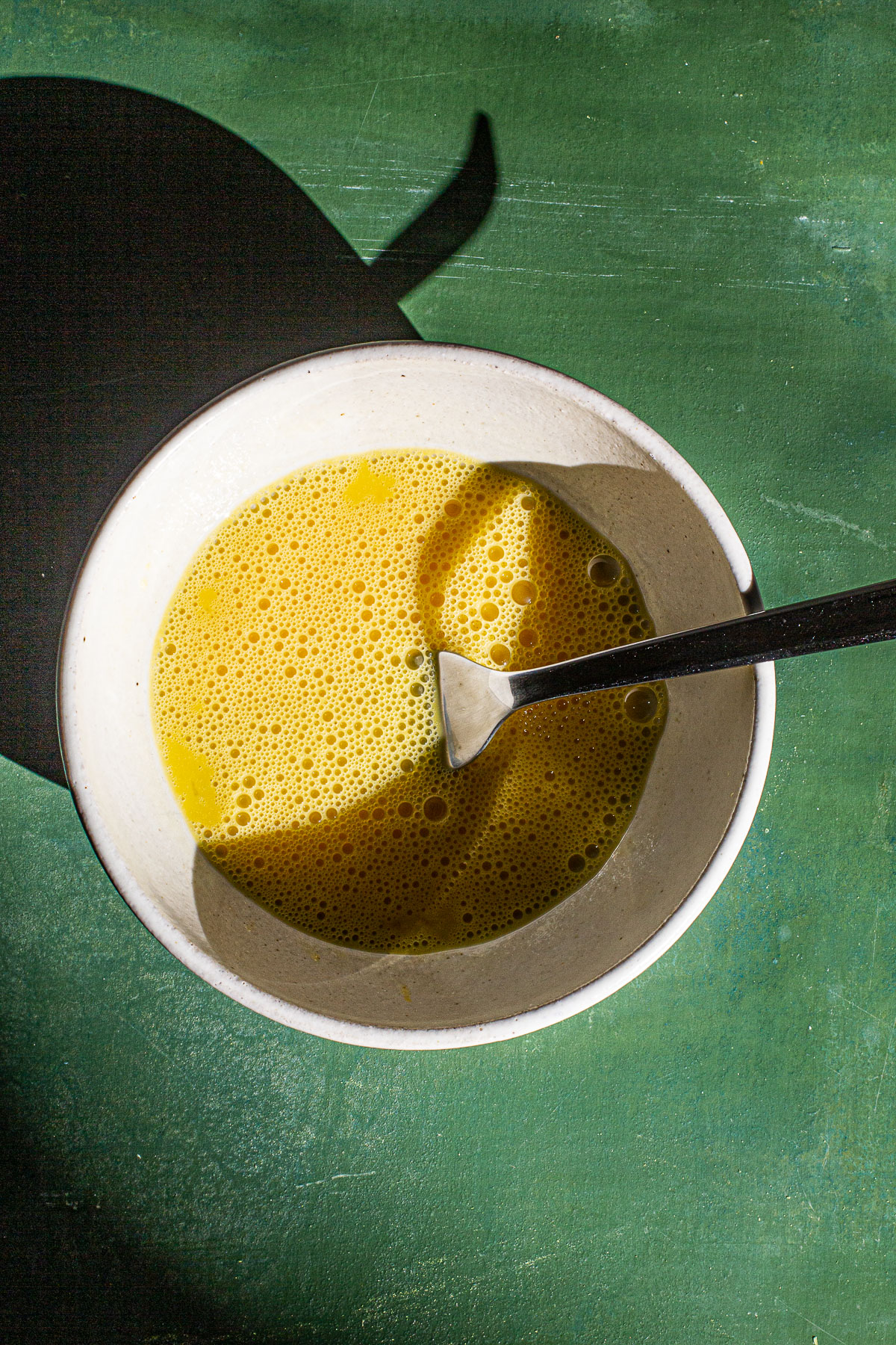 Scrambled Eggs in a Bowl with a fork inside.
