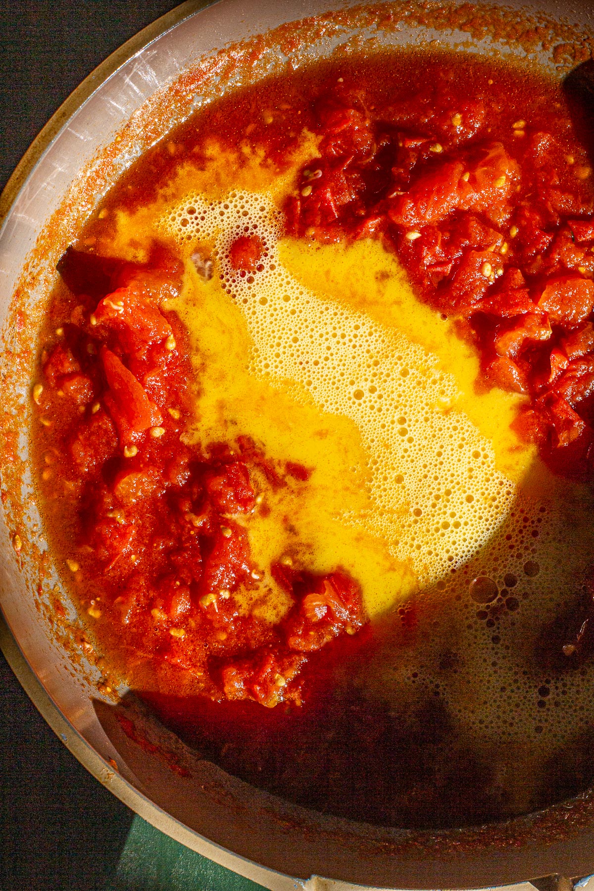 Stewed Tomatoes with scrambled eggs in a skillet.