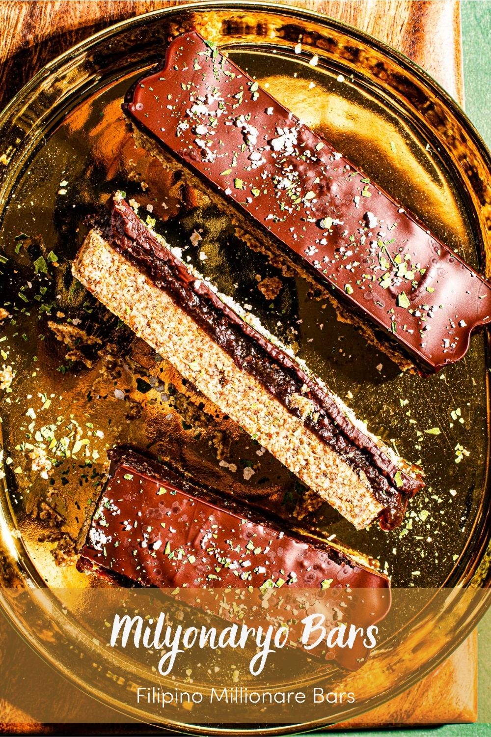Millonariyo Bars (Filipino Style Millionaire Bars) on a gold plate on a small cutting board. 