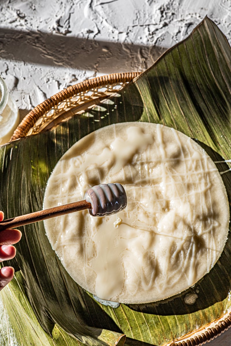 Condensed Milk drizzled on the puton on a banana leaf.