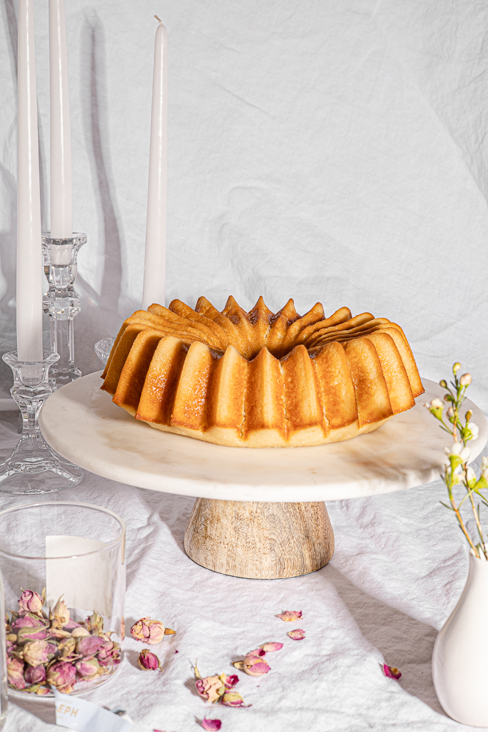 Just baked Ispahan Cake on a marble cake stand.
