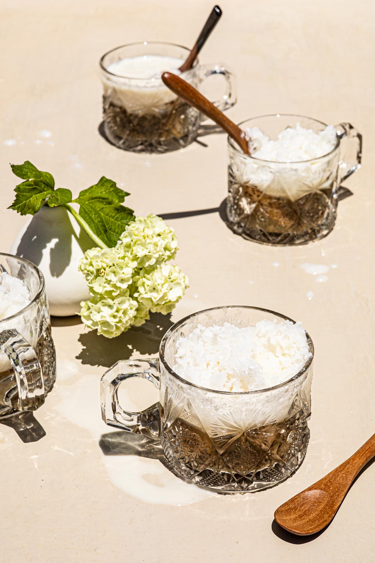 Saba Con Yelo in a glass with a wooden spoon right in front.
