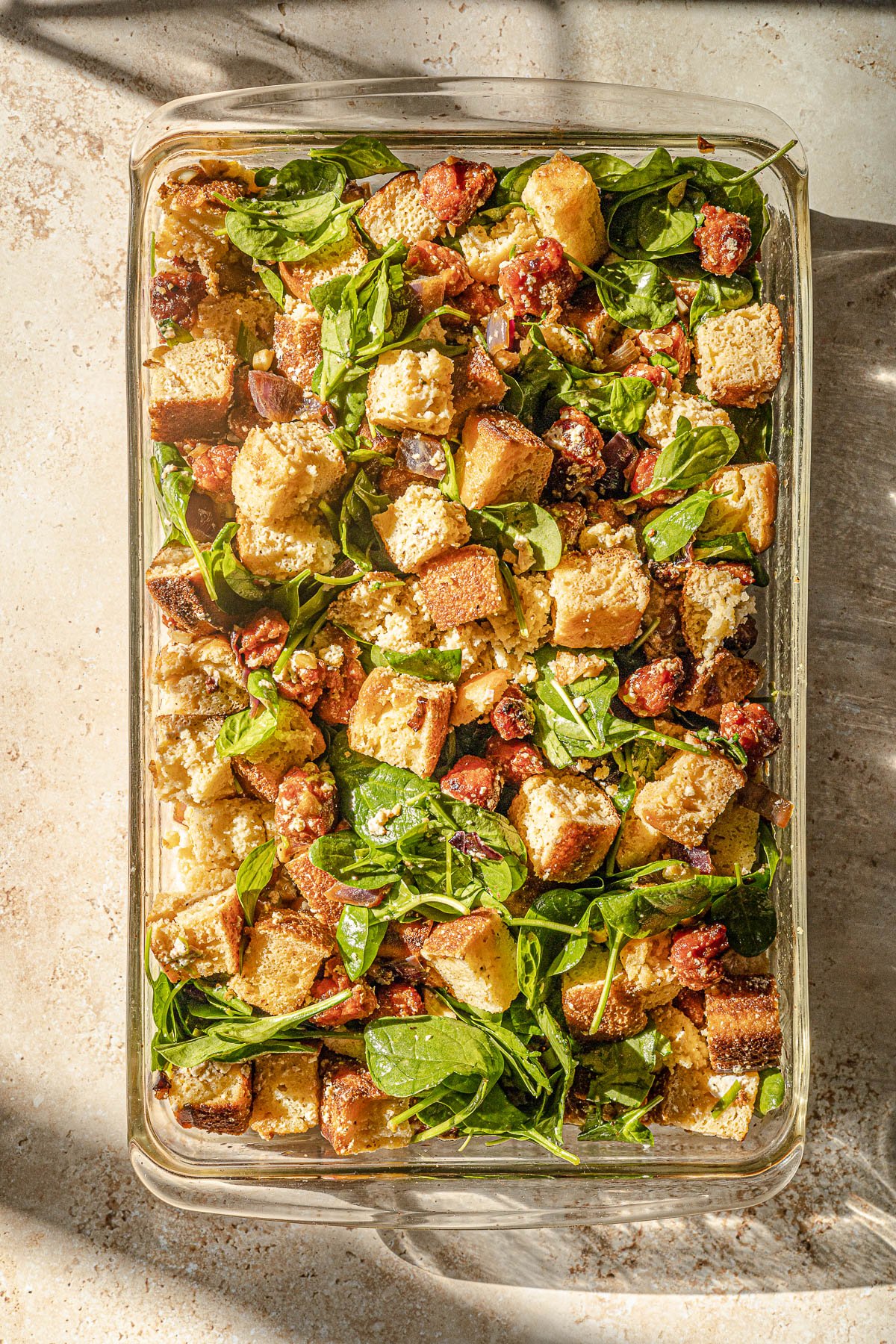 Uncooked Filipino Thanksgiving stuffing in a glass 9x13 baking dish.