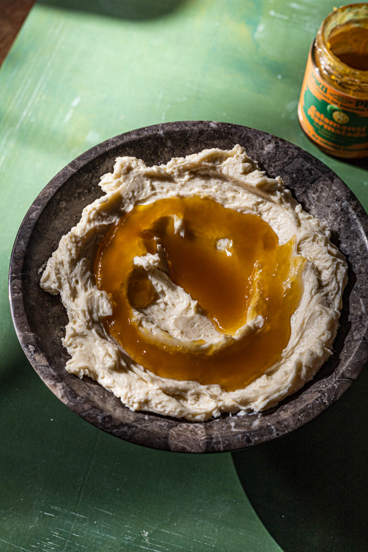 Whipped Kesong Puti with calamansi marmalade in a marble serving bowl.