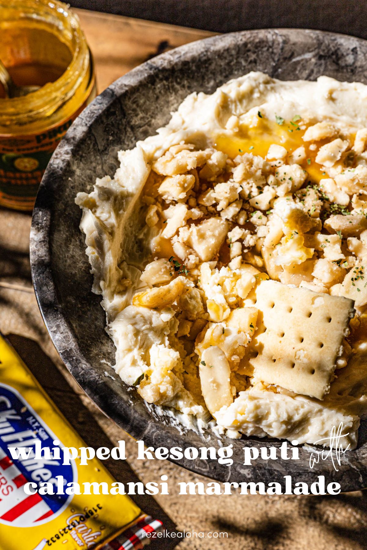 Whipped Kesong Puti with calamansi marmalade and pili nuts. with sky flakes wrapper on the side.