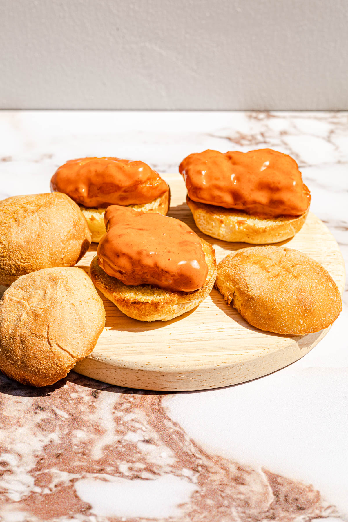 Battered sauced fish on top of pandesal.
