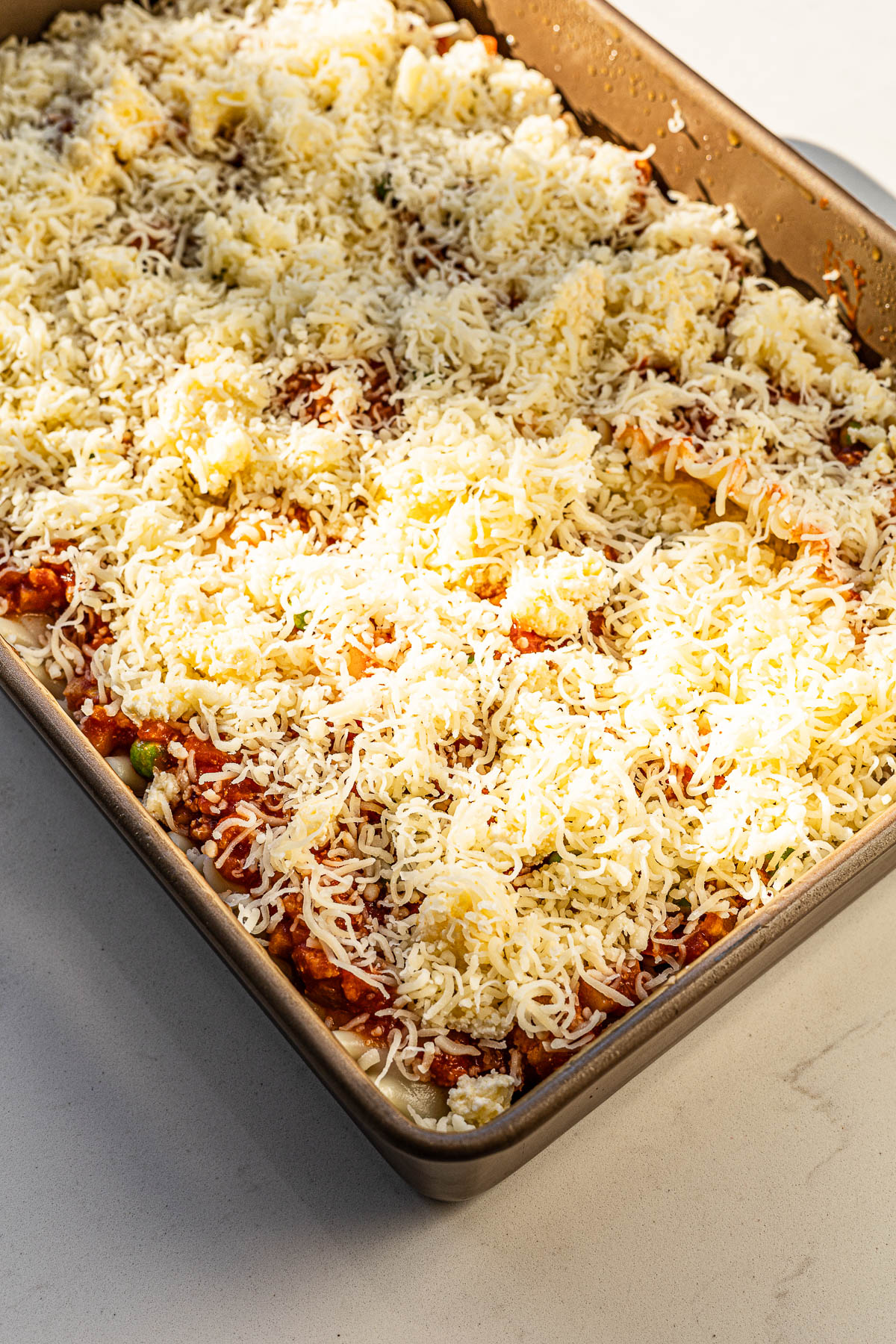 Afritada Lasagna topped with extra mozzarella cheese.