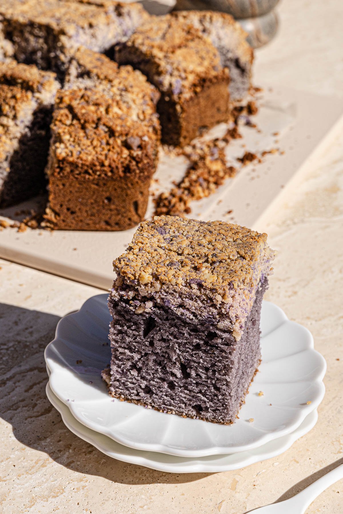 Slice of Ube Coffee Cake on a white plate.