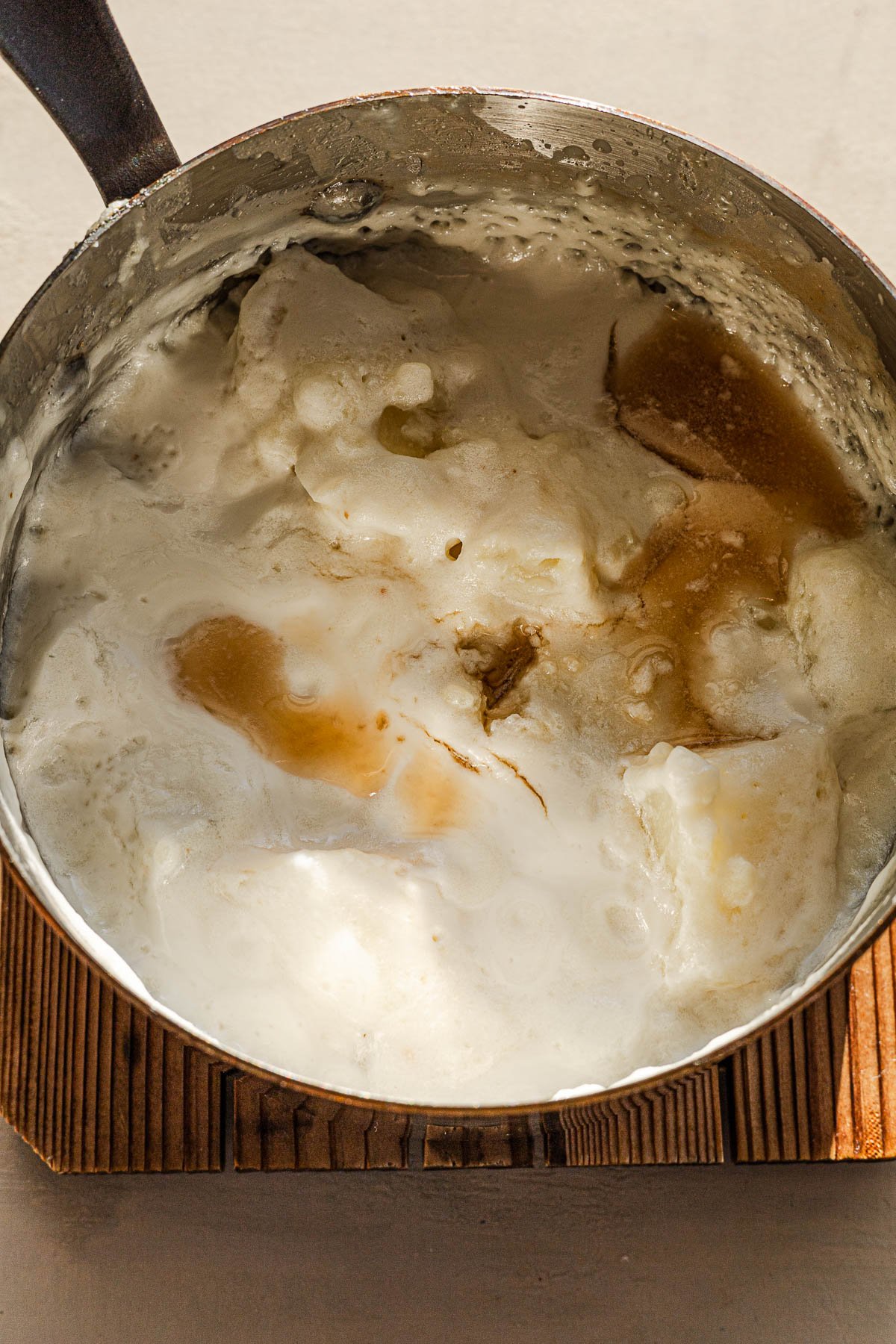 Soft potatoes with fish sauce seasoning in a sauce pan.
