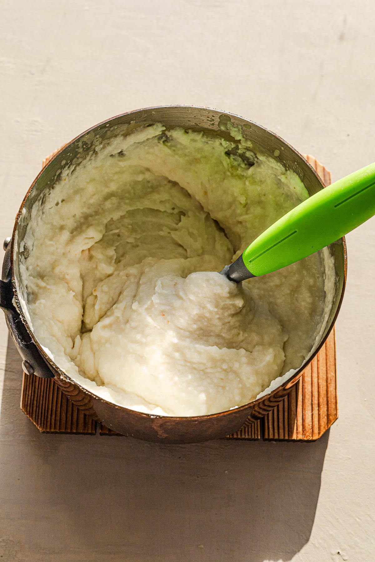 Mashing the Ginataang Mashed Potato.